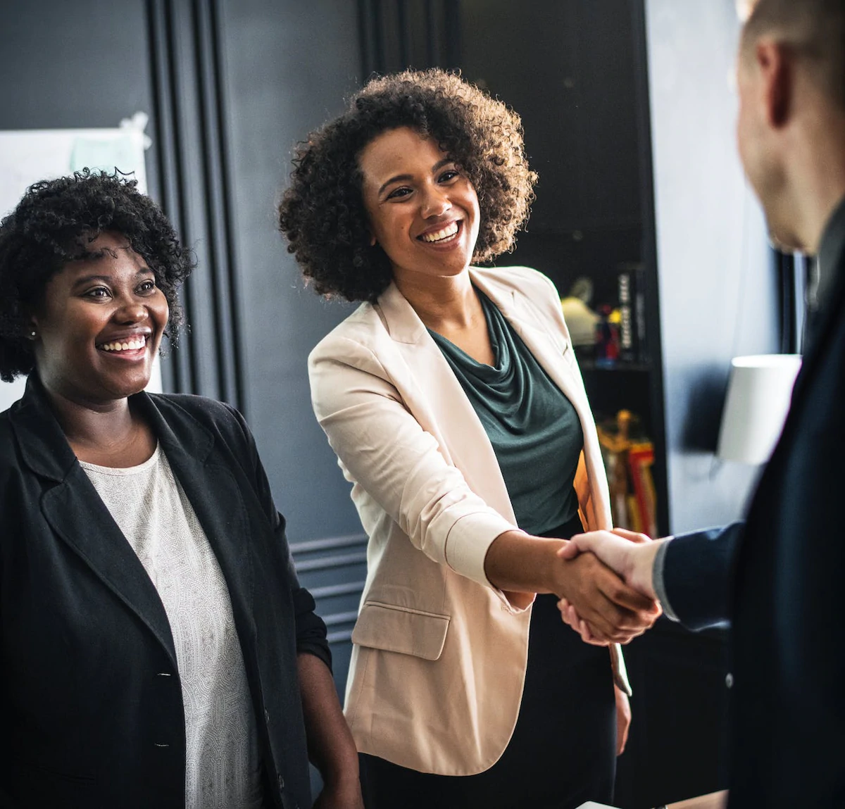Zoey and Thando meeting with a business partner.